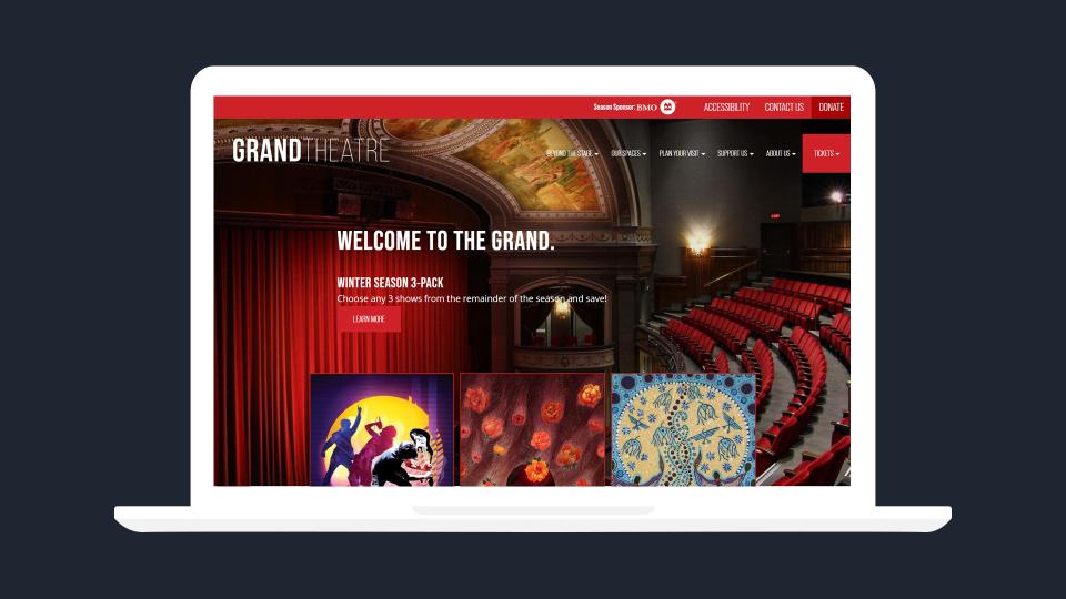 The Grand Theatre website homepage on laptop screen