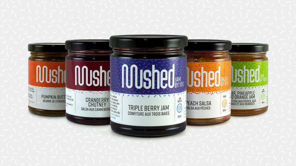 a row of jam jars with colourful labels