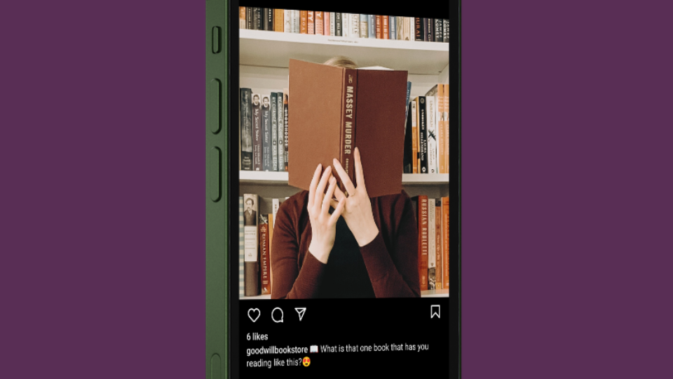 A picture of an Instagram post showing a person holding a brown book up to their face, covering their face with the book