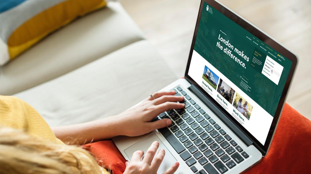 Women on laptop looking at the London Economic Development Corporation Home Page