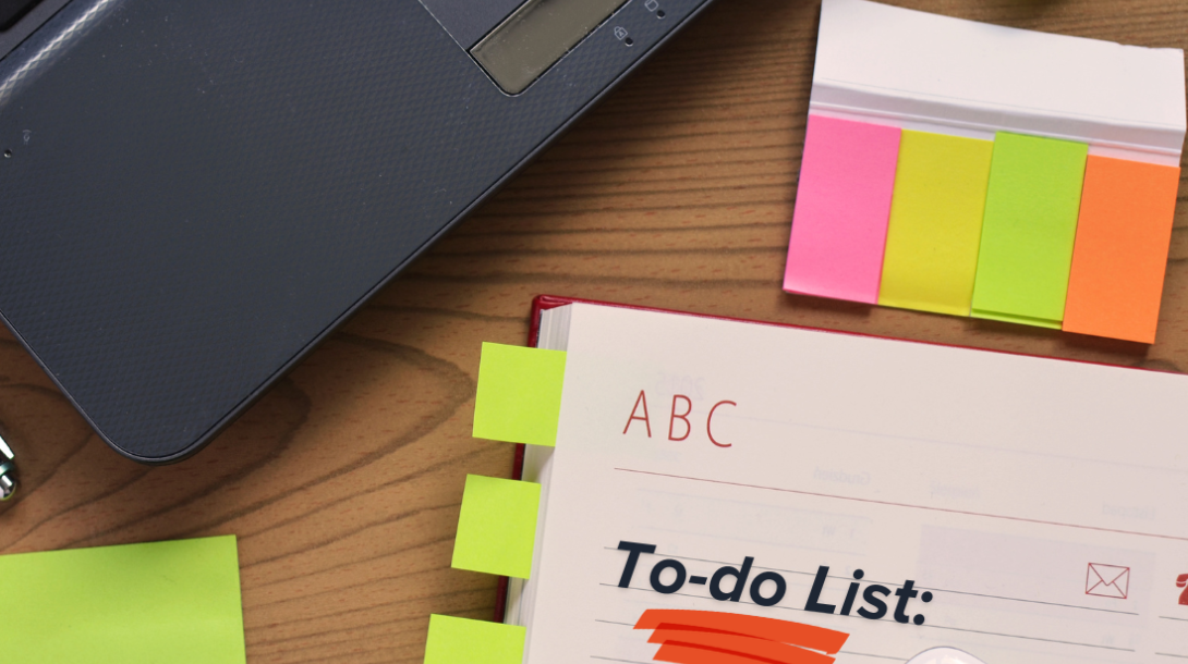 Picture of laptop corner, sticky notes, and notepad