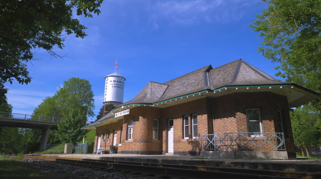 The town of St. Marys water tower behind the train station.