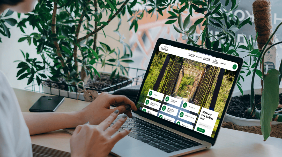 A mockup of a woman on a laptop looking at the Central Huron 