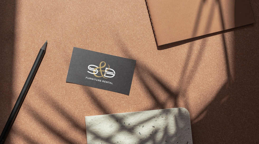 S&D Furniture branded business card on desk