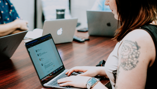 Woman working on laptop in board room