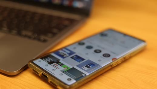 rTraction instagram profile page seen on a mobile phone on a desk.